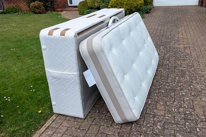 a truck loaded with old mattresses for removal